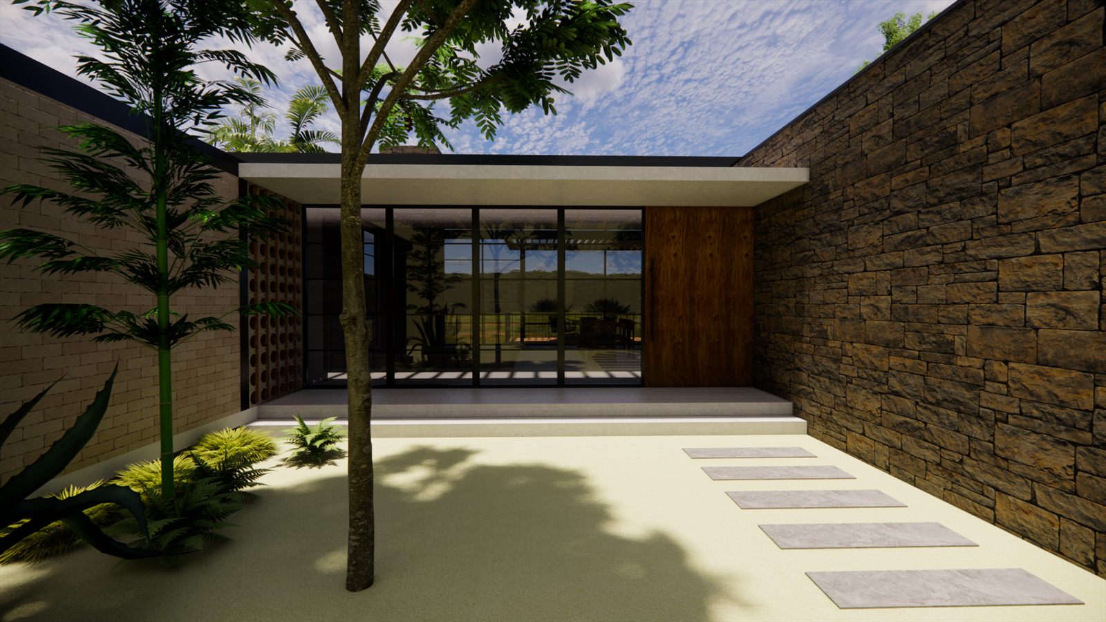 Casa Resiliencia — paved entrance court with a single tree against a stone wall.